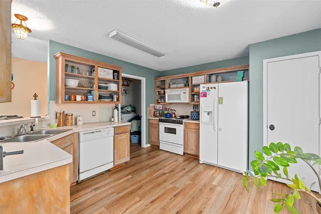 a kitchen with stainless steel appliances a stove a sink and a refrigerator