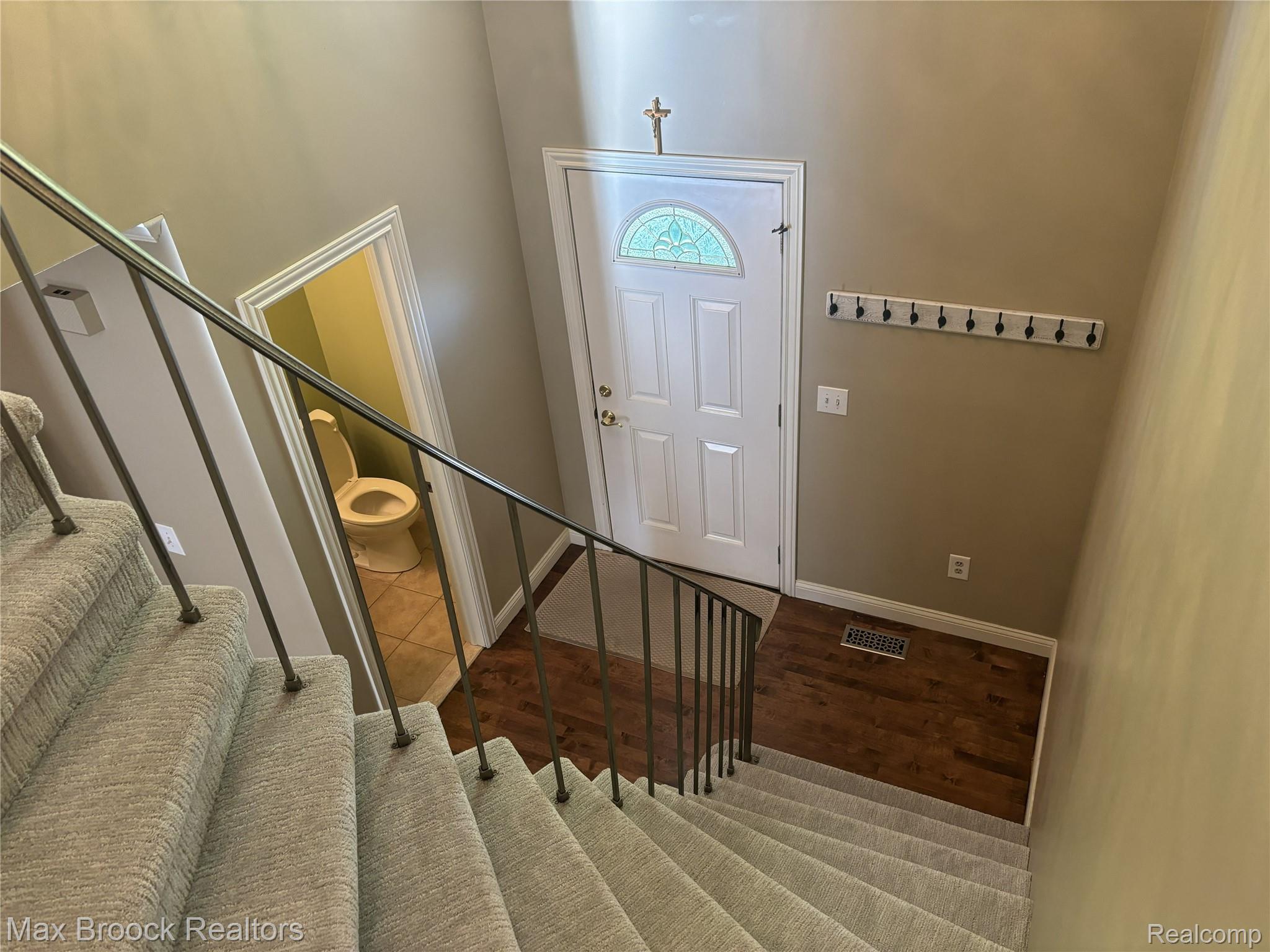 Entryway with a white paneled door featuring a decorative glass insert