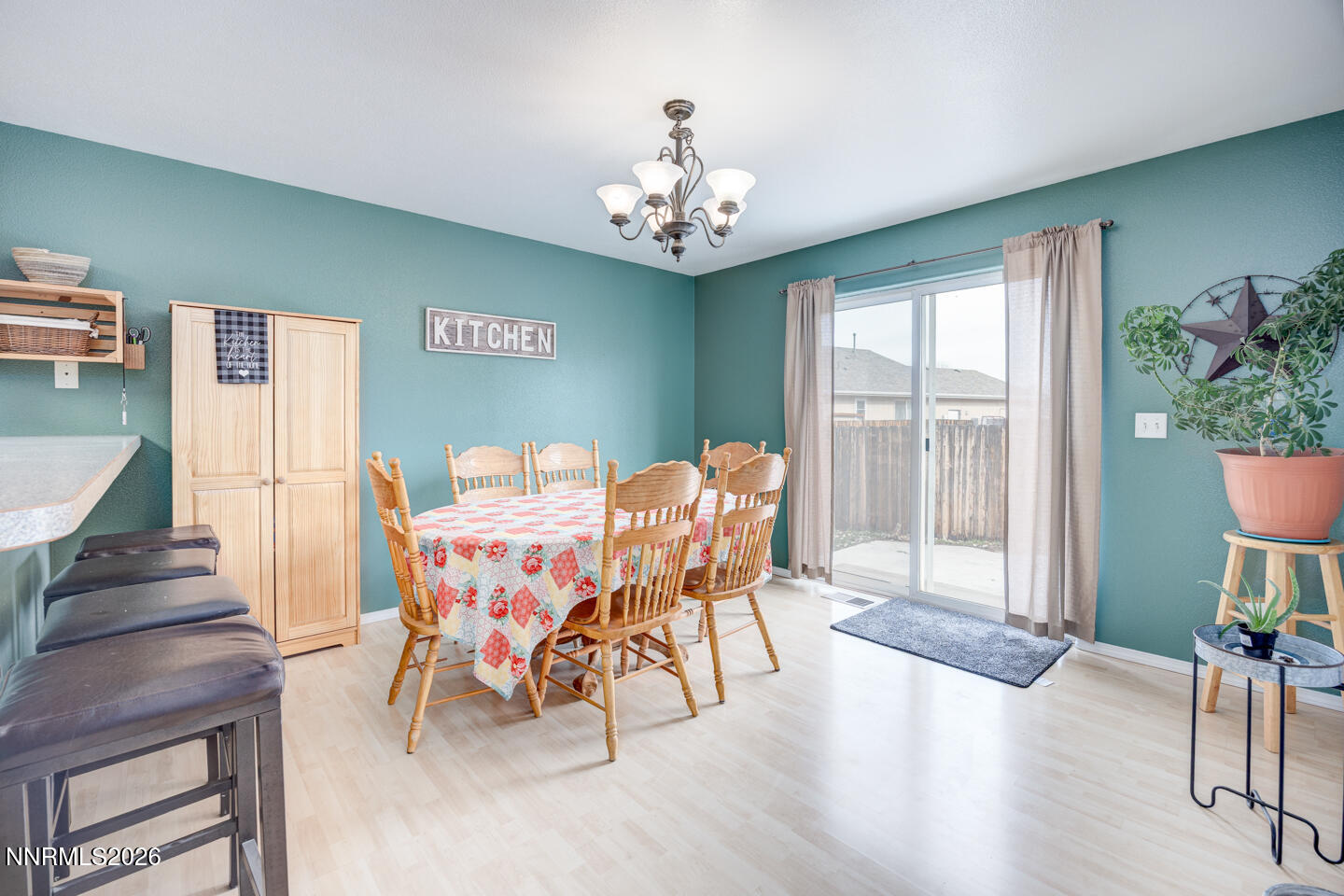 374 Calaway Court Fallon, NV 89406 - Photo 7 of 18 a dining room with furniture a chandelier and wooden floor