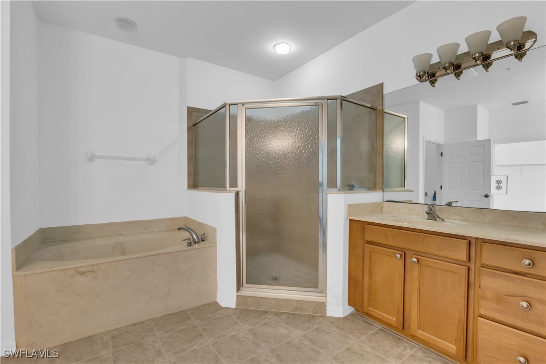3799 Costa Maya Way, Unit 202 Estero, FL 33928 - Photo 18 of 42 a bathroom with a tub sink and mirror