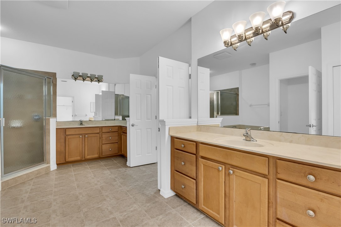 3799 Costa Maya Way, Unit 202 Estero, FL 33928 - Photo 19 of 42 a bathroom with a sink double vanity and a mirror
