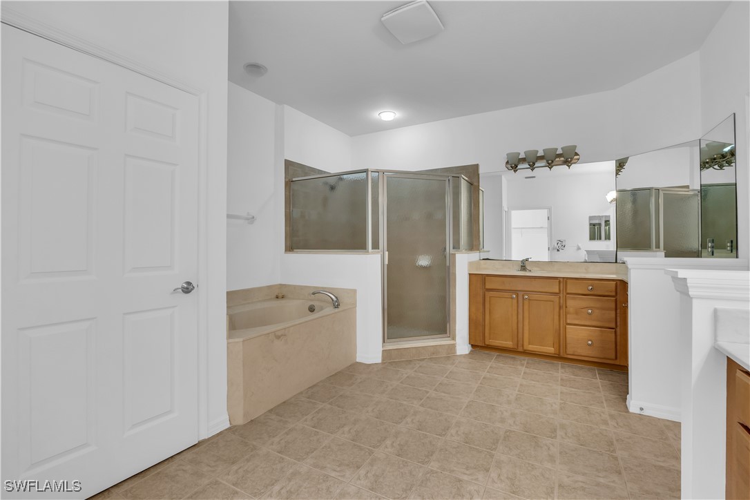 3799 Costa Maya Way, Unit 202 Estero, FL 33928 - Photo 20 of 42 a large bathroom with a tub sink and mirror