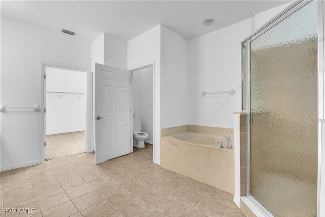 3799 Costa Maya Way, Unit 202 Estero, FL 33928 - Photo 21 of 42 a bathroom with a bathtub and a shower