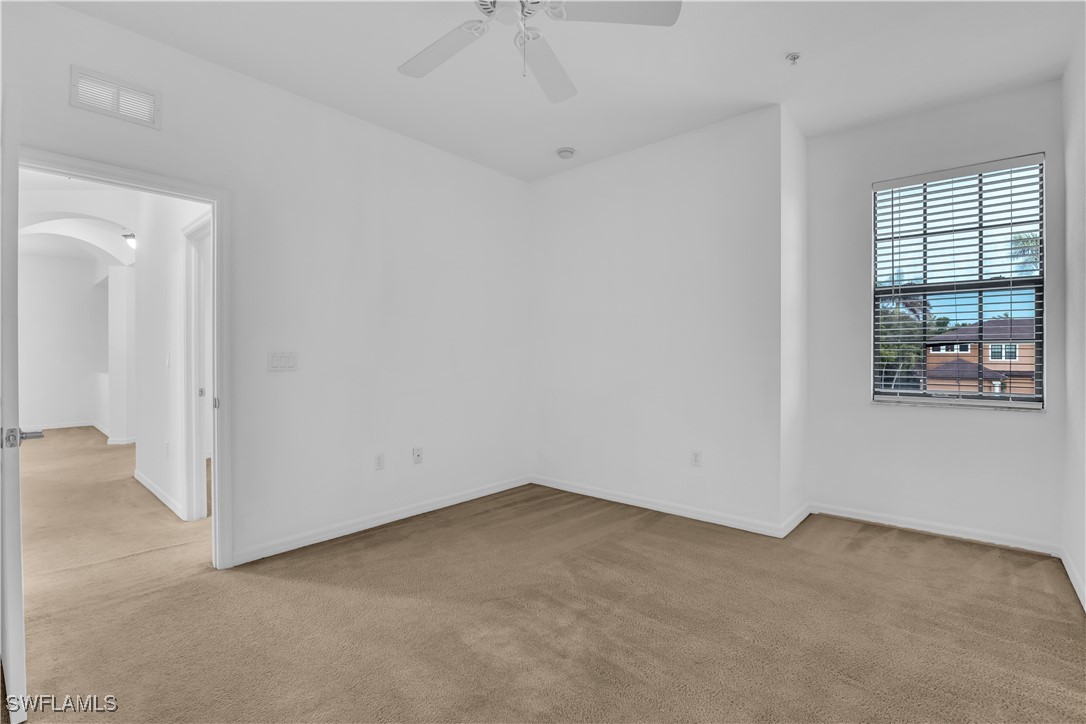 3799 Costa Maya Way, Unit 202 Estero, FL 33928 - Photo 23 of 42 an empty room with windows