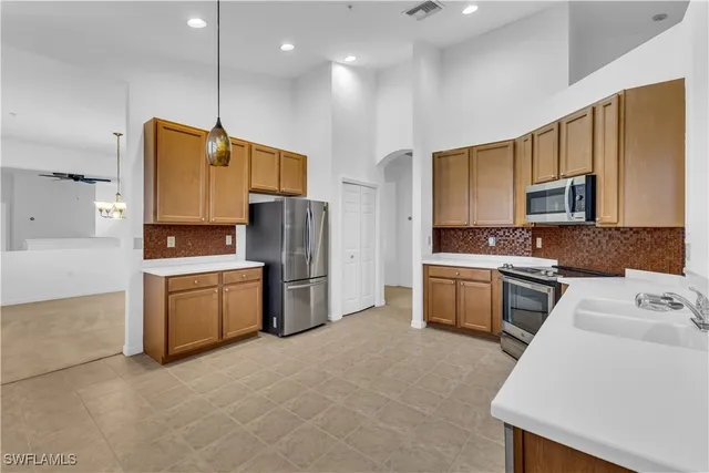 a kitchen with a refrigerator a stove top oven a sink and dishwasher