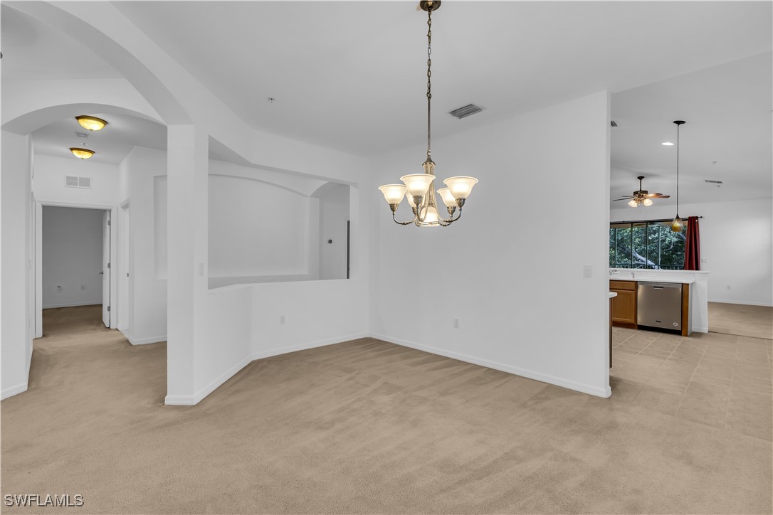 3799 Costa Maya Way, Unit 202 Estero, FL 33928 - Photo 7 of 42 a view of a kitchen with a sink and chandelier