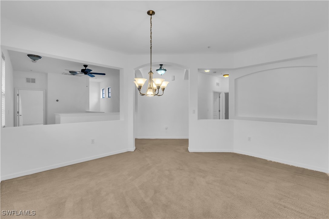 3799 Costa Maya Way, Unit 202 Estero, FL 33928 - Photo 8 of 42 a view of a room with wooden floor and chandelier