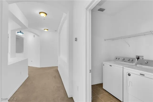 a view of a kitchen with a sink and a refrigerator