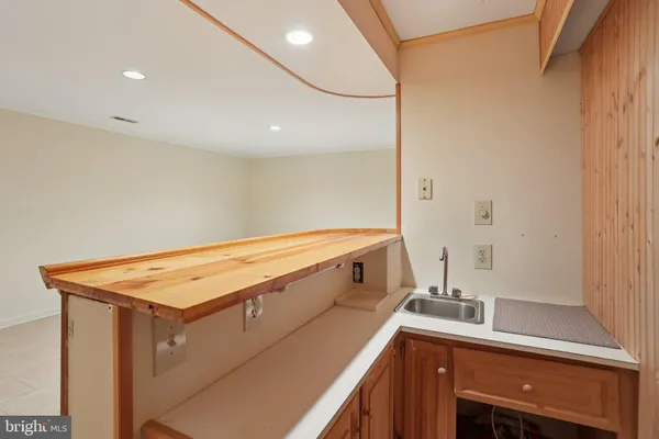 a room with a sink and cabinets