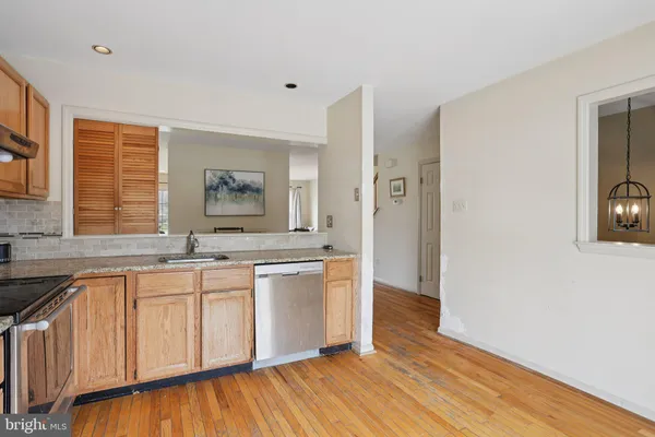 a view of a kitchen counter space with wooden floor and window