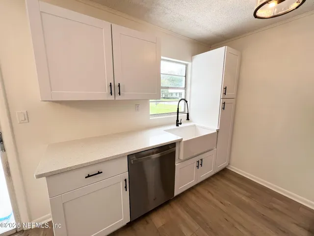 a kitchen with cabinets and window