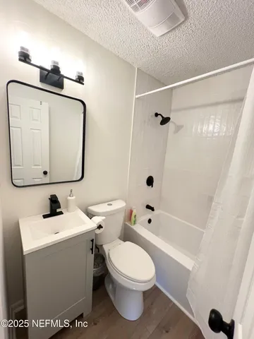 a bathroom with a toilet sink and shower