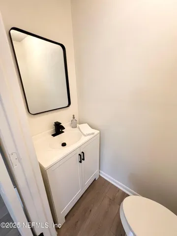 a bathroom with a sink toilet and mirror