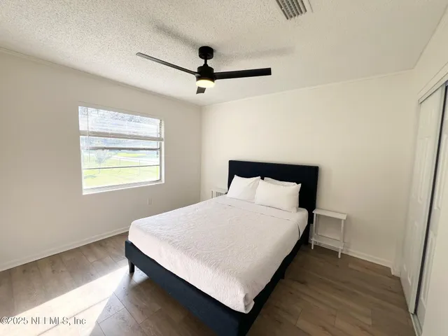 a large bed sitting in a bedroom next to a window