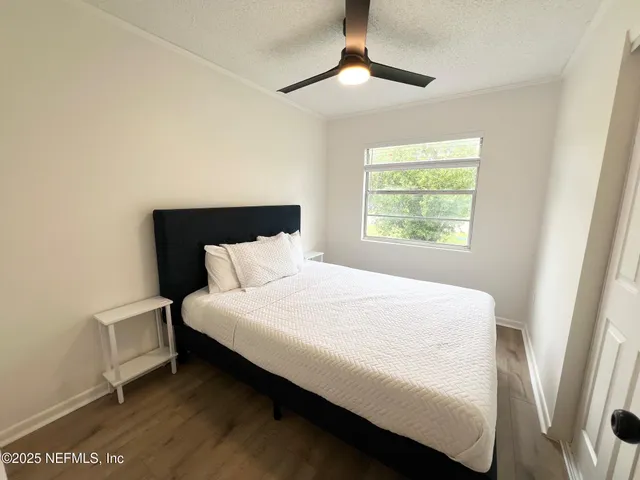 a large bed sitting in a bedroom next to a window