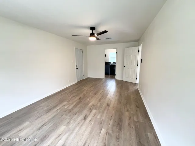 wooden floor in an empty room with a window