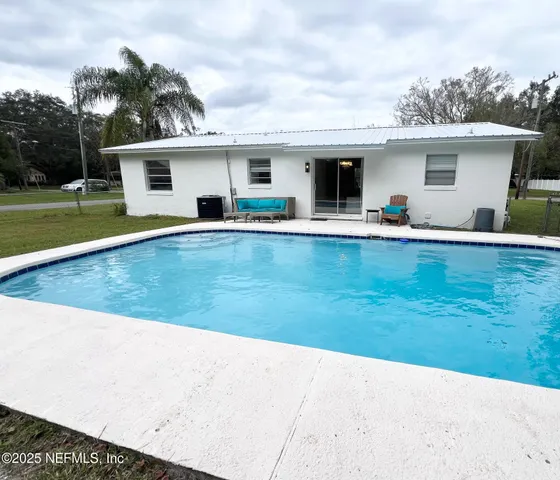 a front view of house with yard seating and green space
