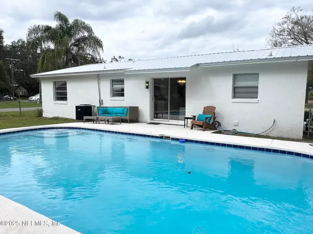 a view of a patio with swimming pool table and chairs