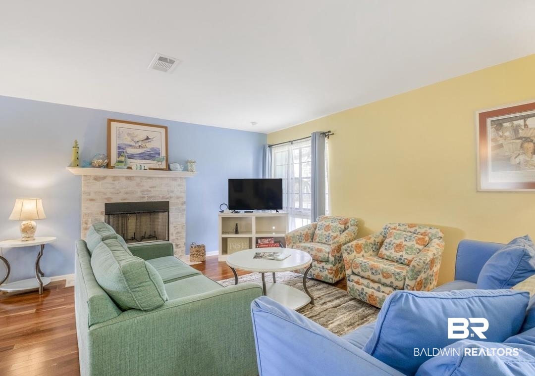 26318 Marina Road Orange Beach, AL 36561 - Photo 11 of 38 Living room featuring wood finished floors and a fireplace