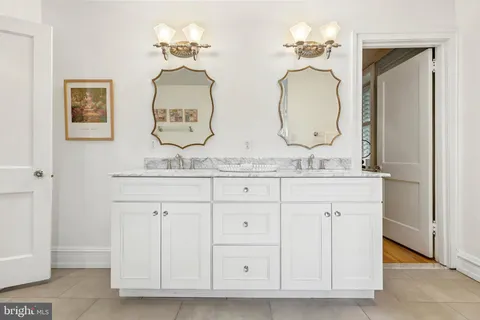 a bathroom with a double vanity sink and a mirror