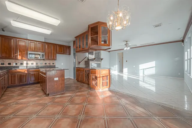 a kitchen with stainless steel appliances granite countertop a stove a sink a refrigerator and cabinets