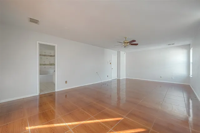 an empty room with a empty space and windows