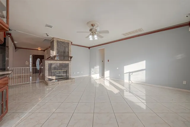 a view of a livingroom with furniture and chandelier fan