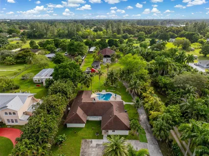a view of a house with swimming pool and sitting area