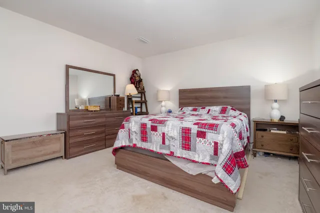 a bedroom with a bed and dresser