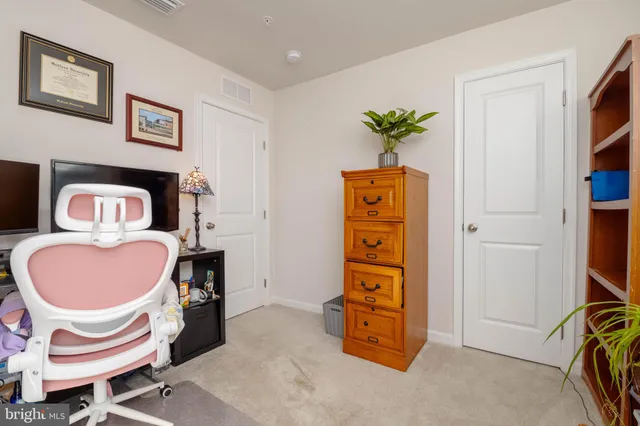 a dining room with furniture and a potted plant