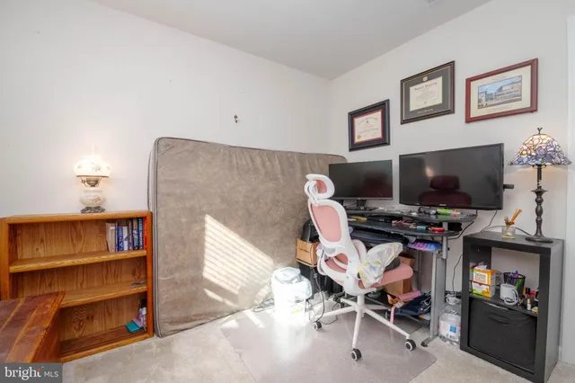 a work room with furniture and a flat screen tv