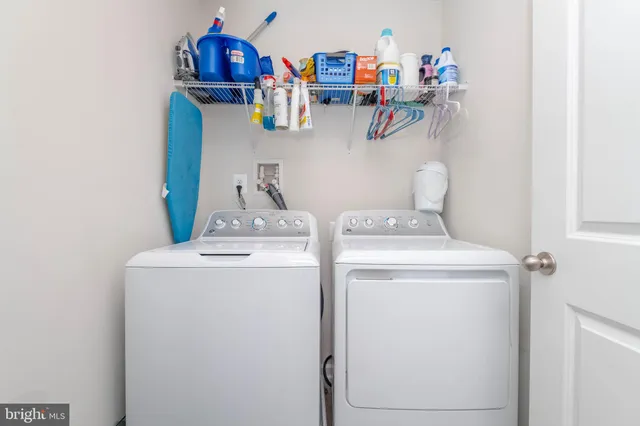 a view of storage and utility room with washer and dryer