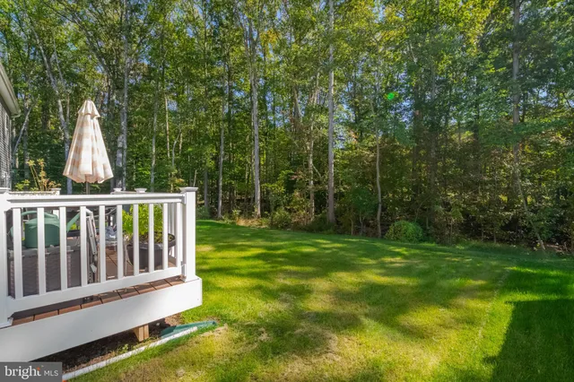 a view of a wooden deck and backyard
