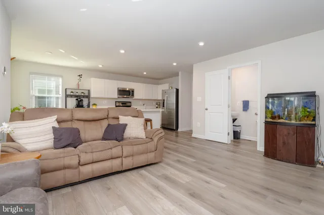a living room with furniture and kitchen view