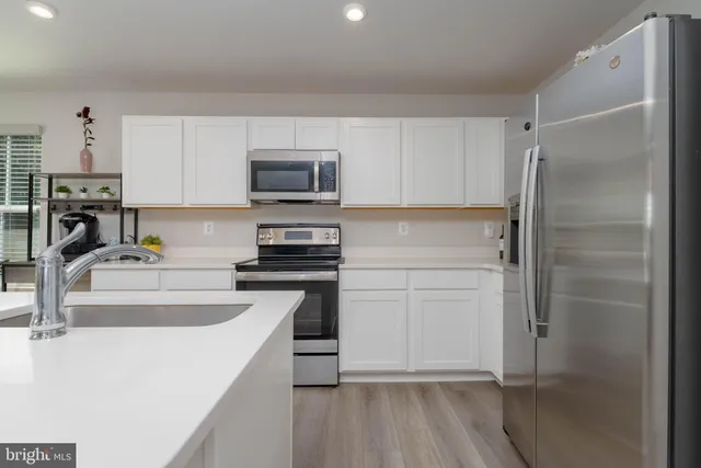 a kitchen with a refrigerator stove and sink