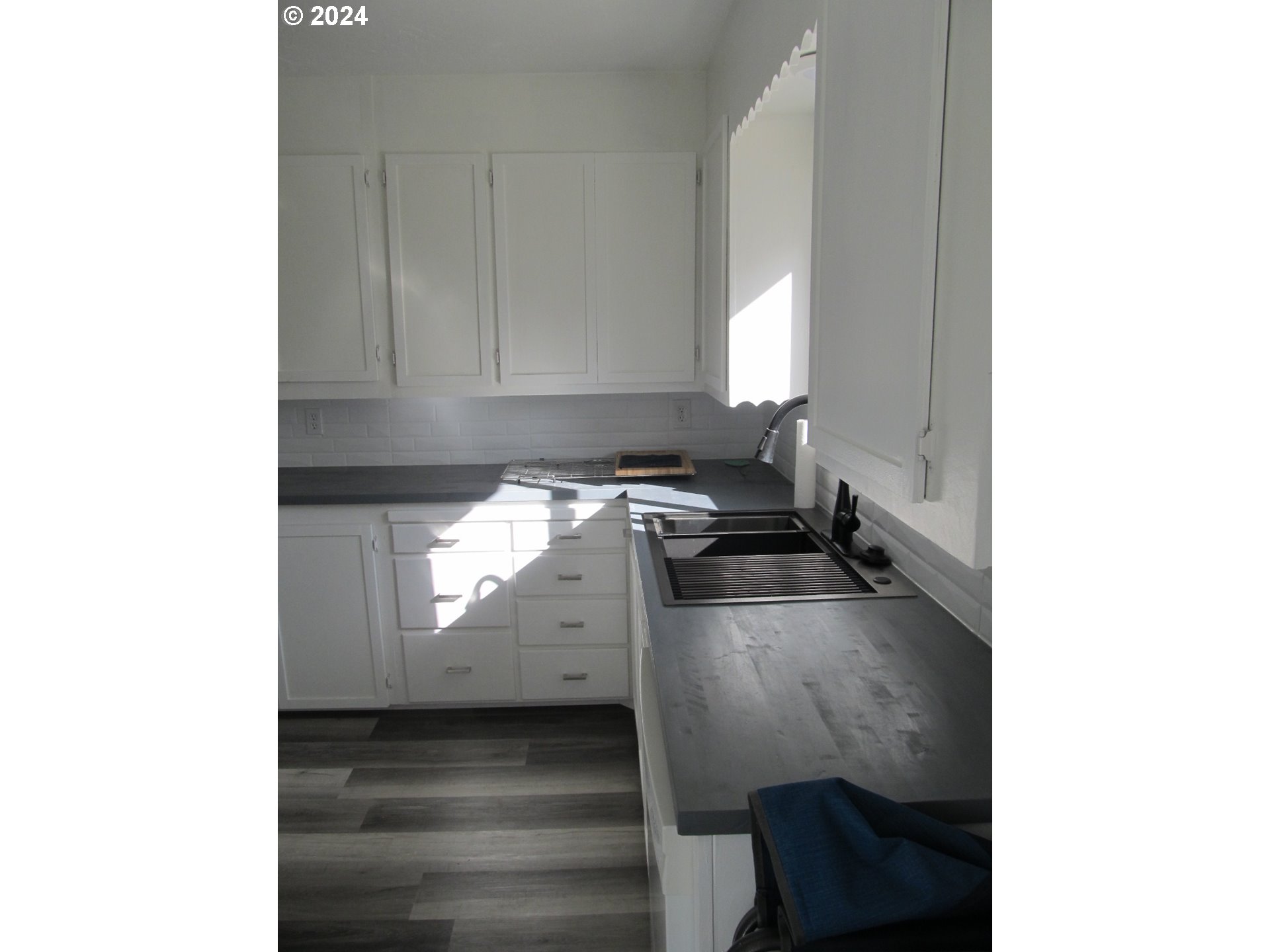 1890 East Hooker Road Hermiston, OR 97838 - Photo 11 of 32 a kitchen with a sink and cabinets