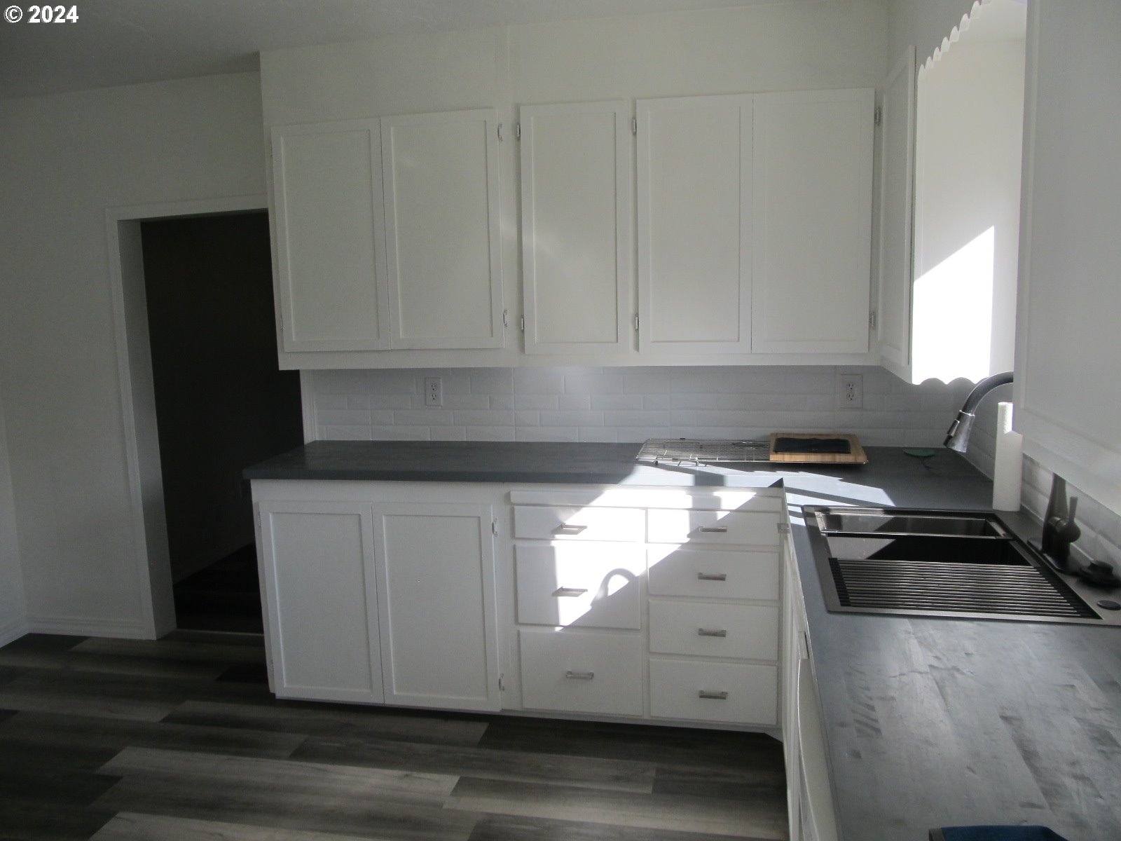 1890 East Hooker Road Hermiston, OR 97838 - Photo 12 of 32 a kitchen with granite countertop white cabinets and stainless steel appliances
