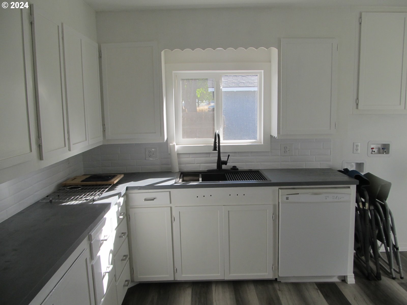 1890 East Hooker Road Hermiston, OR 97838 - Photo 9 of 32 a kitchen with granite countertop white cabinets and sink