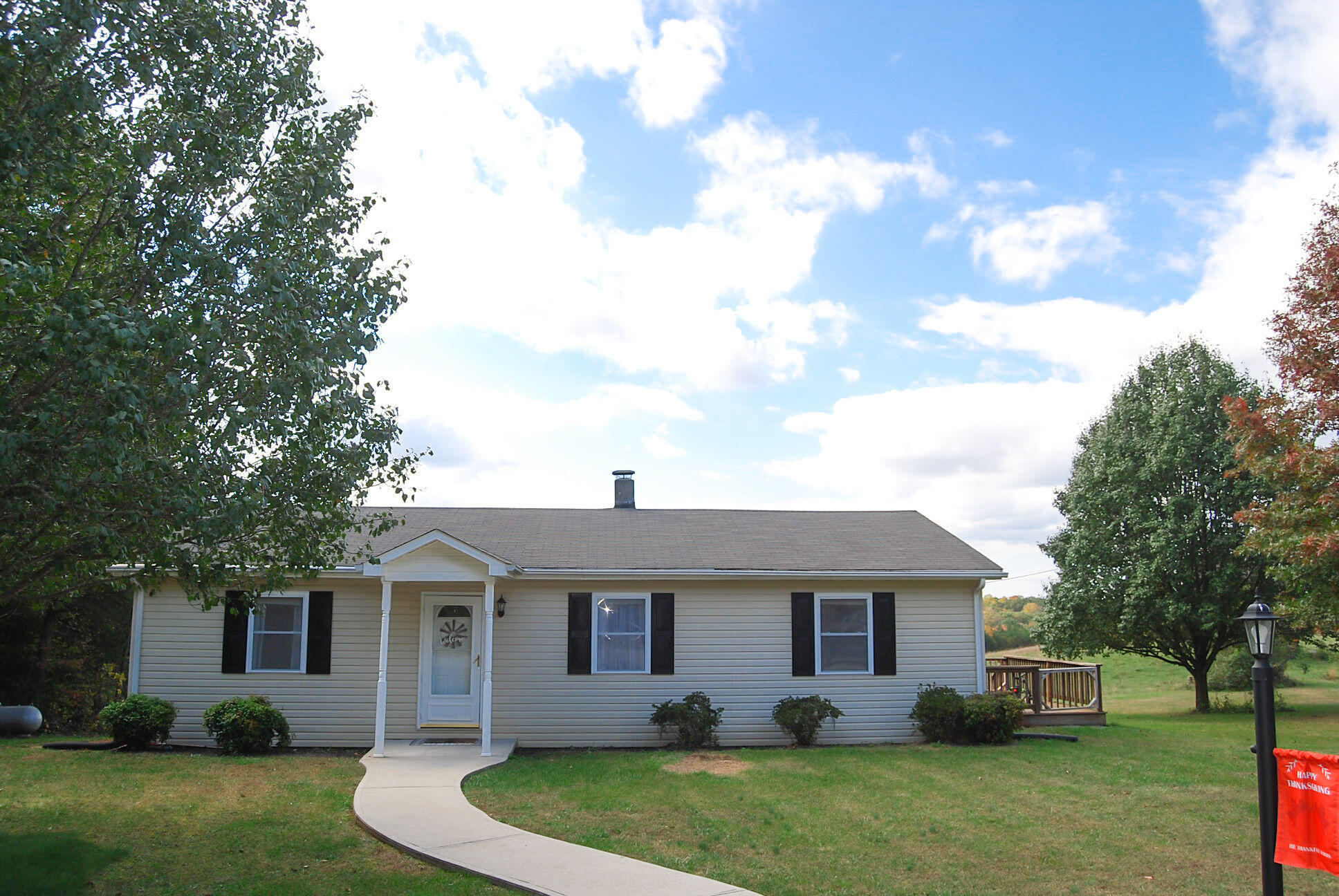 a front view of house with yard and green space