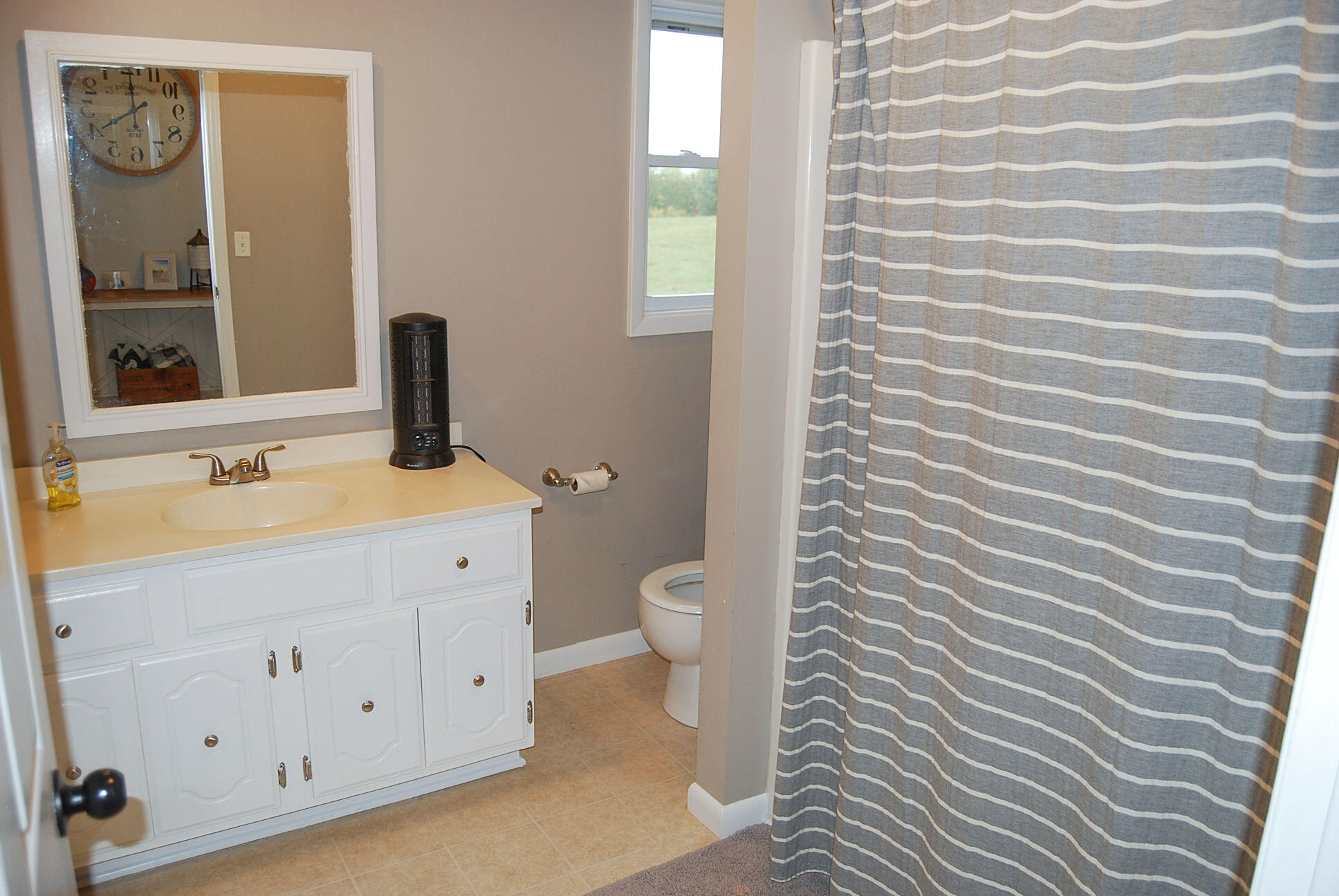 410 Mill Run Road Chatham, VA 24531 - Photo 18 of 34 a bathroom with a toilet sink and a mirror