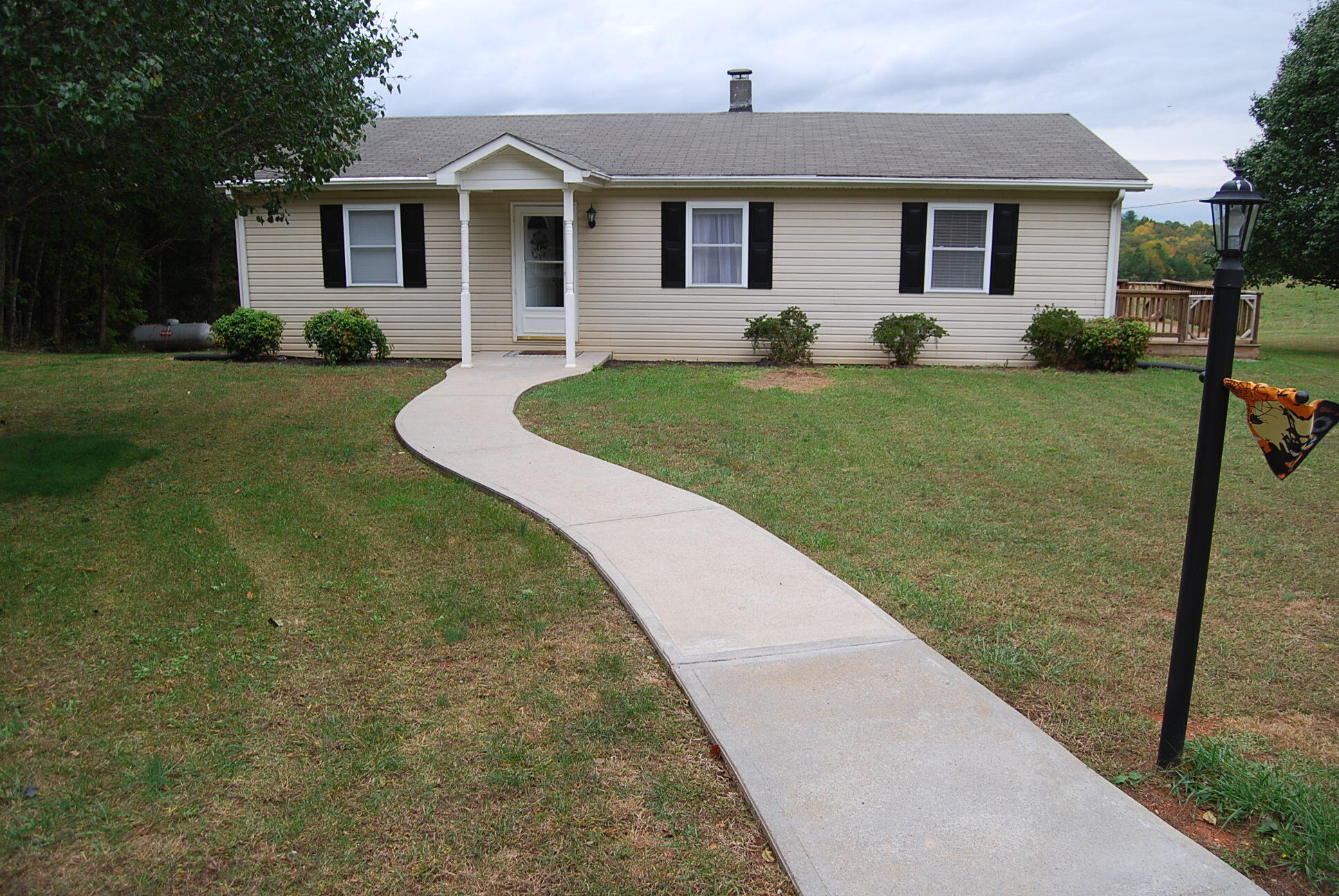 410 Mill Run Road Chatham, VA 24531 - Photo 2 of 34 a front view of a house with a yard and trees