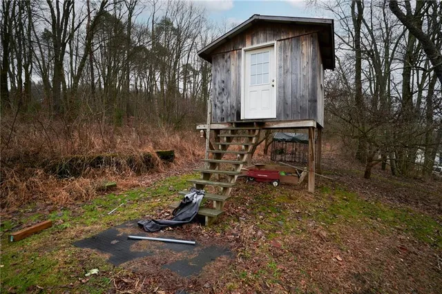 a view of a patio with table and chairs with wooden floor and fence