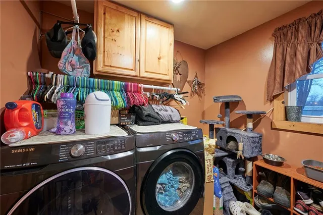 a view of kitchen with furniture and stainless steel appliances