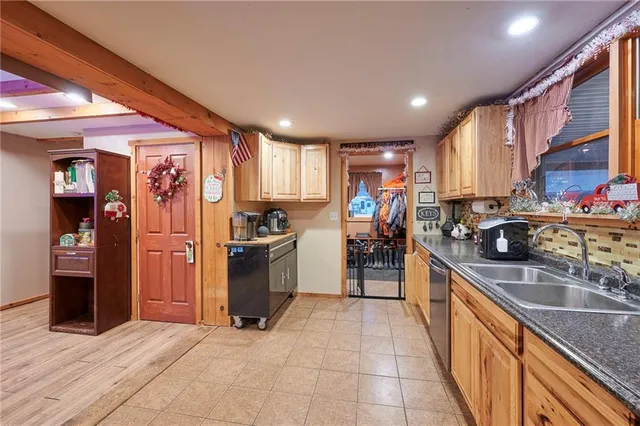 a room with lots of wooden furniture and a potted plant