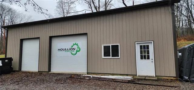 a front view of house with yard and trees