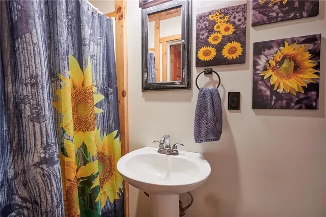 a bathroom with a toilet a sink and mirror