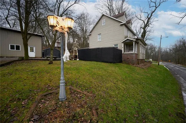 a view of a house with a yard and lawn chairs