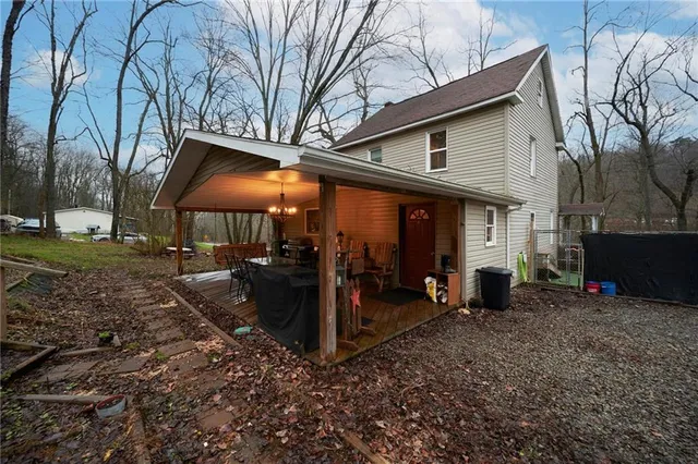 a view of a yard with wooden fence