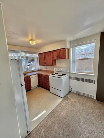 a kitchen with stainless steel appliances a refrigerator and a stove top oven