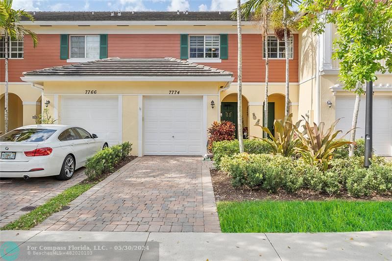 a couple of cars parked in front of a house